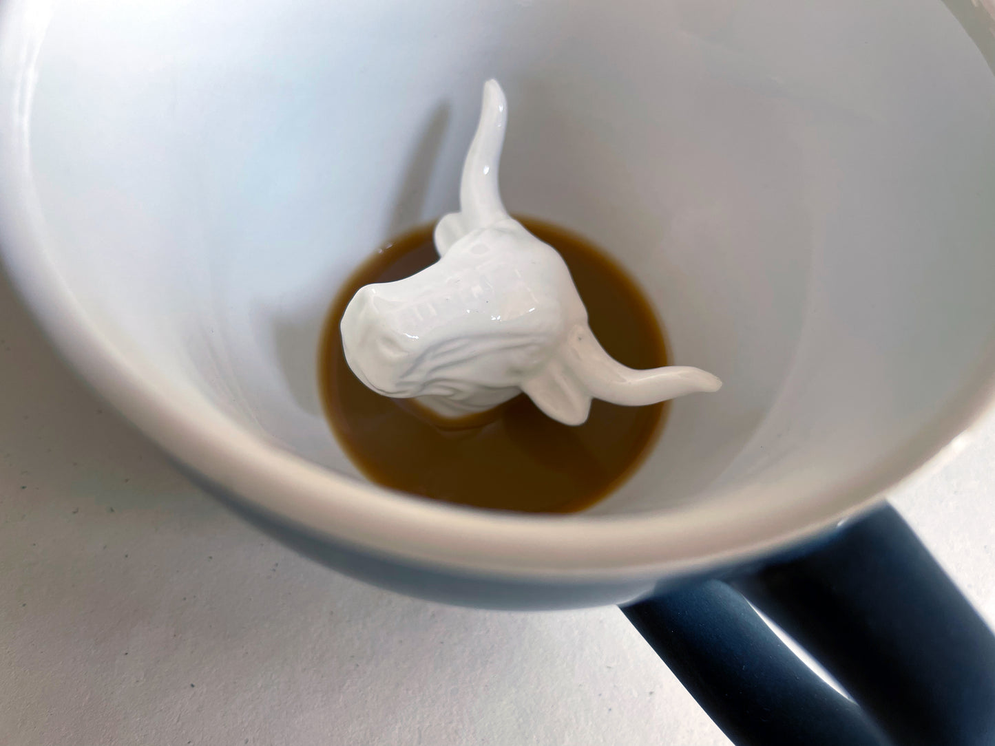 Ceramic Bull at the bottom of the coffee mug