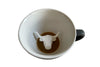 Ceramic Cow at the bottom of the coffee mug